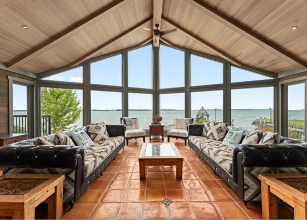 Beautiful living area featuring floor to ceiling windows and large seating area